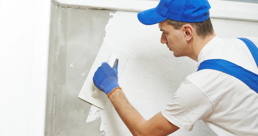 Plasterer smoothing a wall
